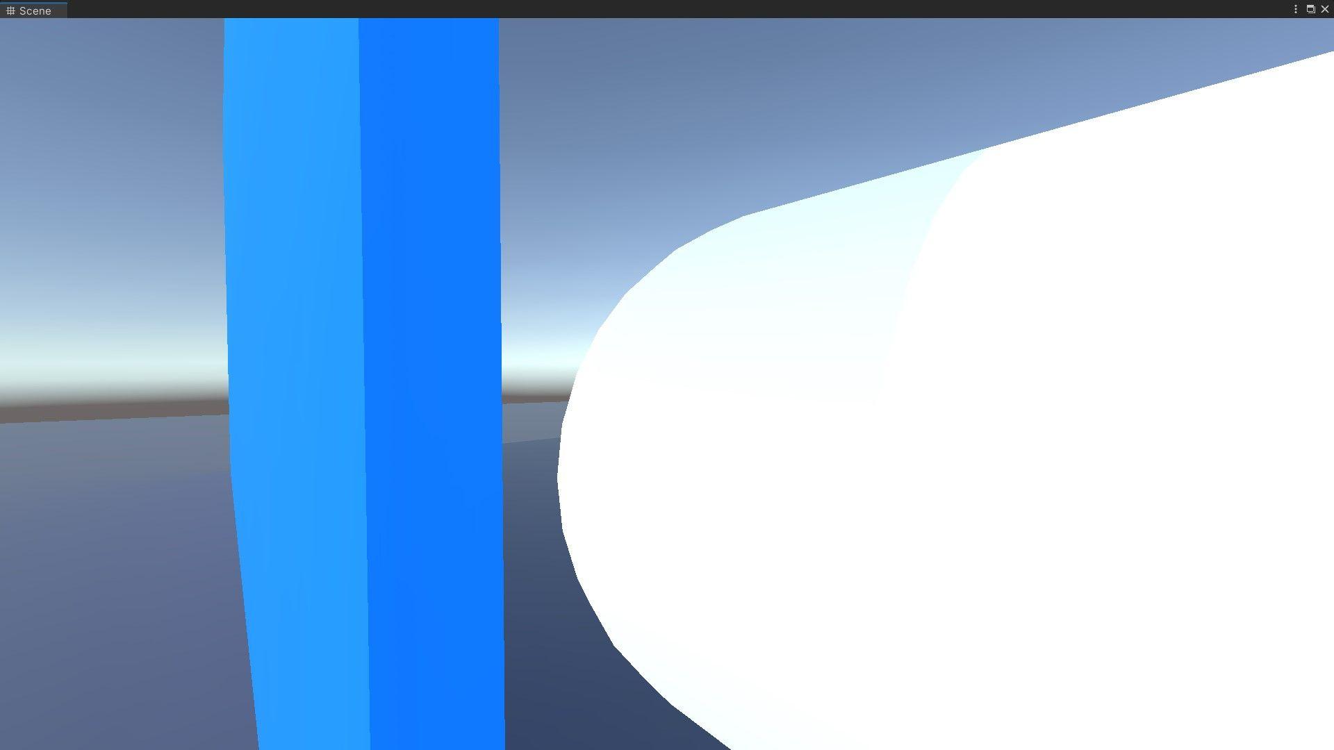 Blue wall casting a weak shadow on a white capsule.